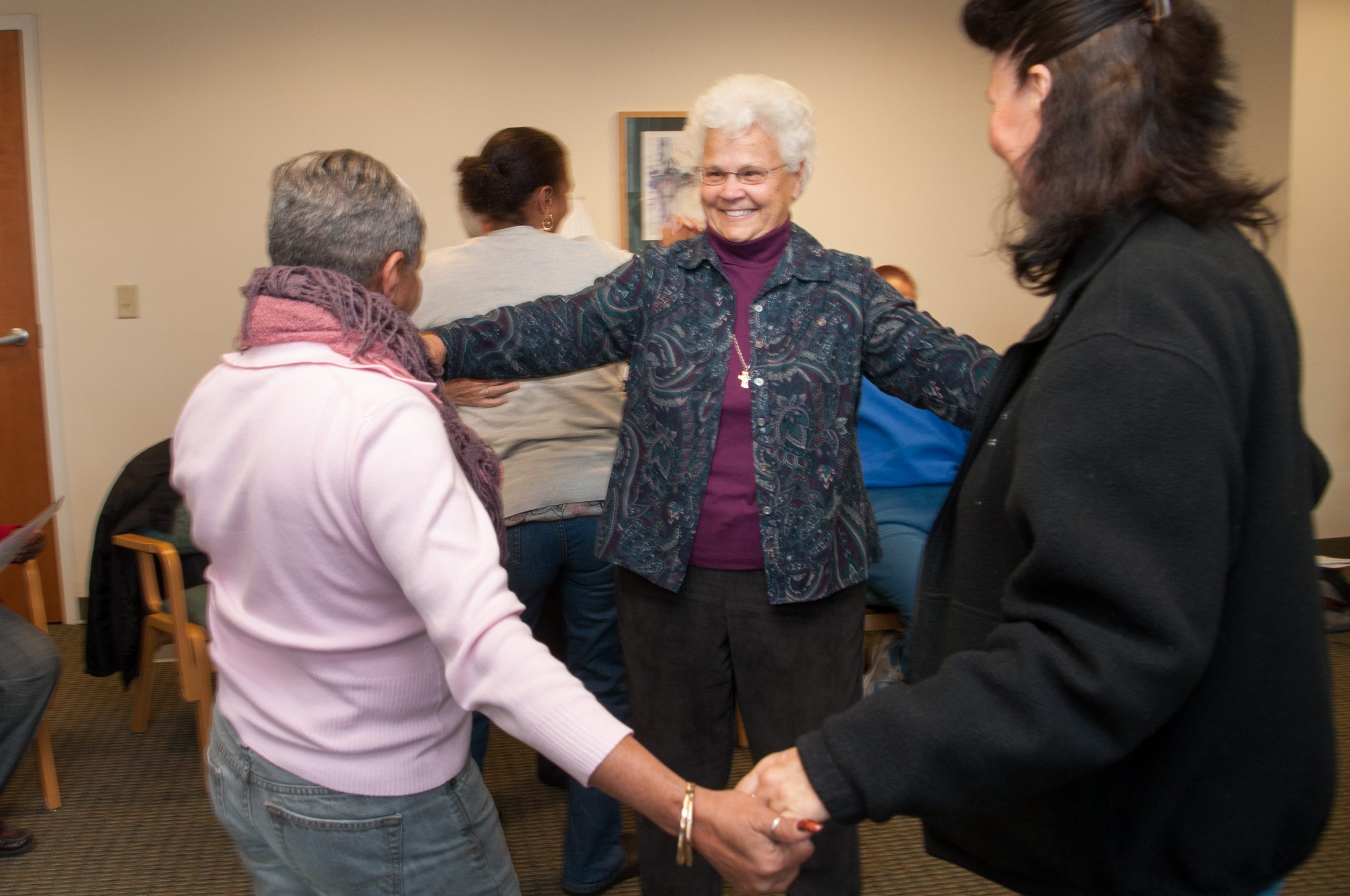 Sister Eileen dances with women who are homeless during a retreat at Mercy by the Sea in Madison, Connecticut. Credit: Catherine Walsh.