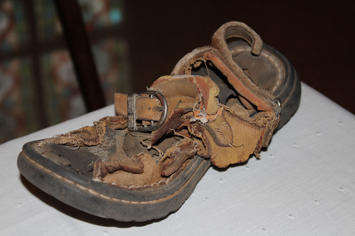 A dusty sandal discarded in a desert by an immigration