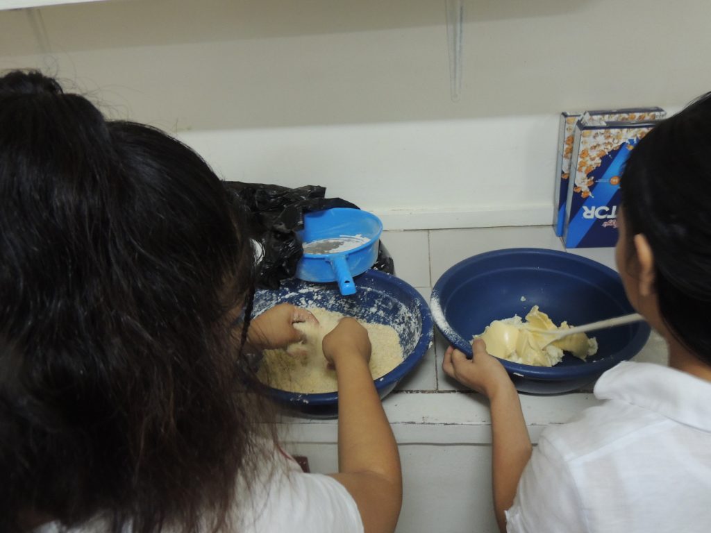 Residents of Together in Peace prepare a meal at the safe house.