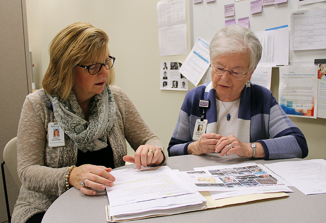 Sister Marilynn Wittenauer (right) and Sharon Neumeister of Mercy Neighborhood Ministry discuss plans for upcoming volunteer opportunities in the St. Louis area. In her ministry, Sister Marilynn works with the staff to connect area health and social service agencies with Mercy co-workers looking to live the charism of Catherine McAuley.