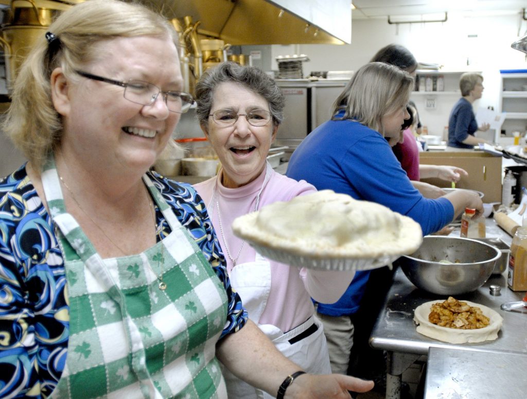 Kathy Reilly, assistant registrar at Saint Joseph’s College, and Sister Sylvia helped to bake apple pies in 2009 as a Thanksgiving treat for those who are hungry. Credit: John Patriquin/Portland Press Herald.