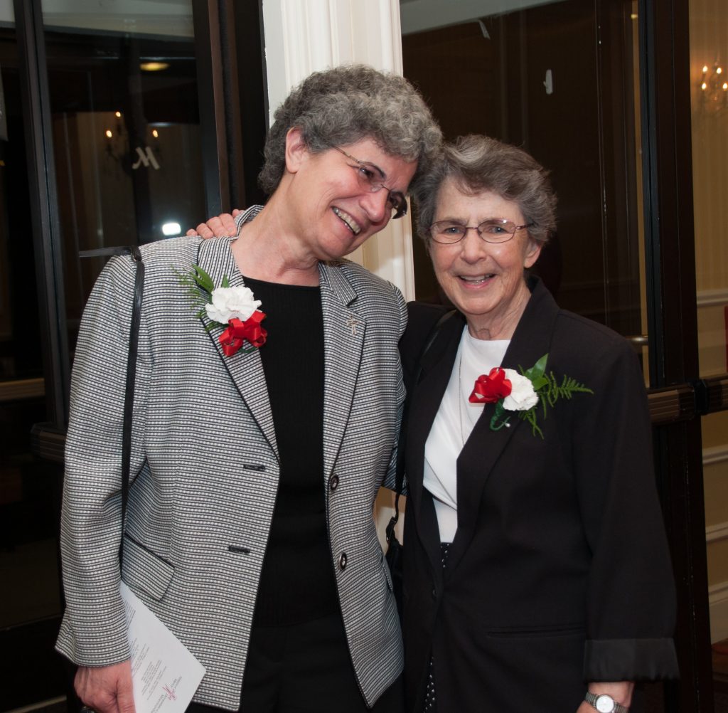 Sister Michele Aronica and Sister Sylvia Comer, long-time colleagues, close friends and housemates at Saint Joseph’s College, enjoy a moment together at a 2015 gala celebrating 150 years of the Sisters of Mercy in Maine. Credit: Catherine Walsh/Sisters of Mercy.