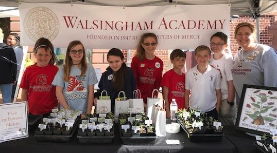 Walsingham Academy students Ida Pellei, Lauren Digges, Gabrielle Camp, Isabella Kennedy, Luke Brooks, Carter Perry, Josh Powell, and Kim Ward, Science Coordinator, distribute milkweed plants to the community. 
