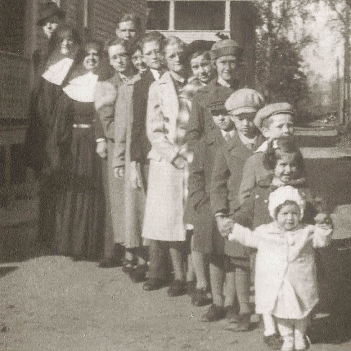 The Graber children lineup. All 15 kids posed for this photo in 1938 when Sister Kay (in front) was one and a half years old.