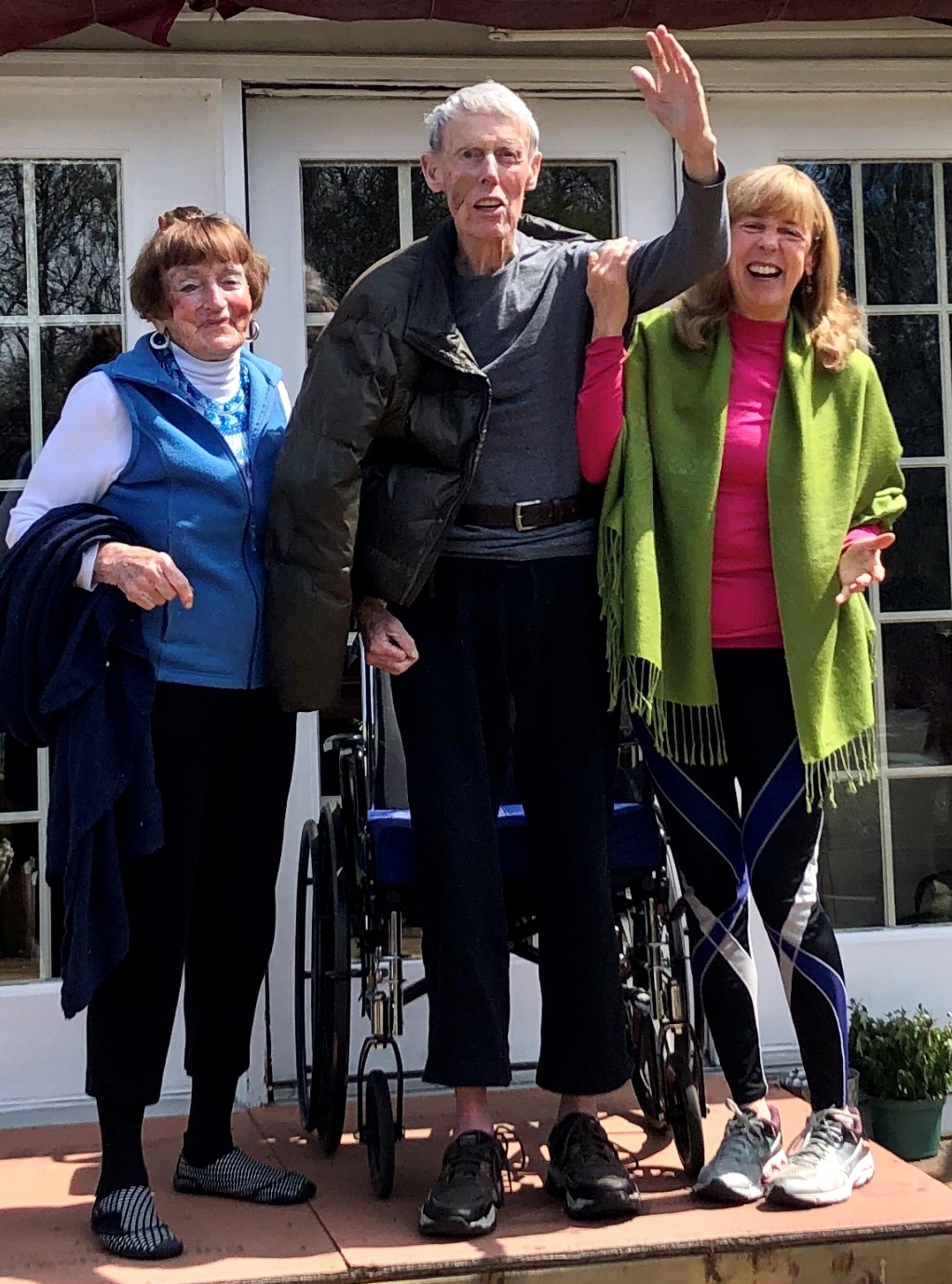 Easter Sunday greetings! Peg, Joe and Cathy Walsh wave to family members visiting from the safety of the yard.