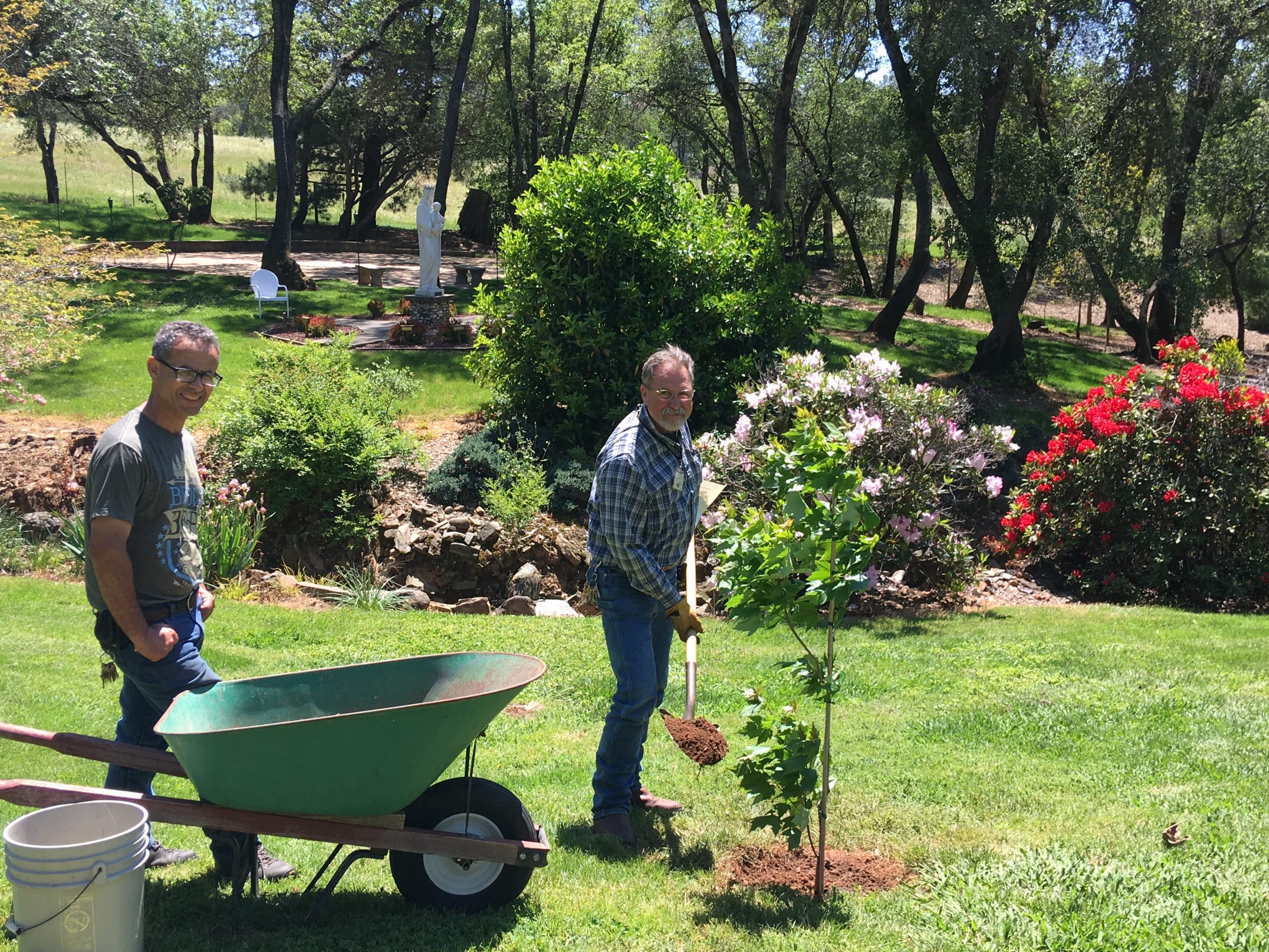 An image of two West Midwest staff members' tending to the sisters' grounds in Auburn, California